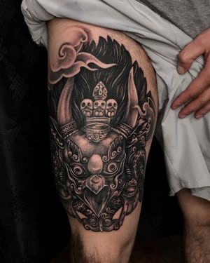 Elegant illustrative tattoo on upper leg featuring a beautiful bird and traditional mask design by talented artist Avi.