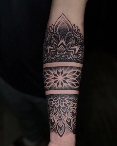 Elegant ornamental pattern tattoo created by Avi, blending dotwork technique with mandala motif for a unique design.