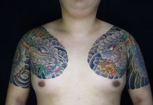Exquisite japanese chest tattoo featuring a intricate snake and flower design by talented artist Hansol Jung.