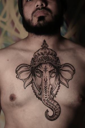 Get mesmerized by this intricate black and gray chest piece featuring a detailed elephant, ornate pattern, and regal crown. Designed by the talented Alejandro Gonzalez.