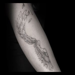 Experience the beauty of blackwork with stunning illustrative wings designed by Drone on your forearm.