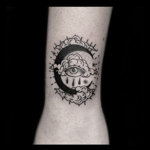 Drone's illustrative design features clouds, moon, and an eye in a striking blackwork style on the forearm.