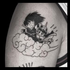 Get an illustrative blackwork tattoo of Goku on your upper arm, done by the talented artist Drone. Stand out with this unique design!