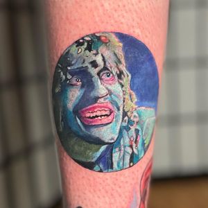 Experience the artistry of Michaelle Fiore with this striking realism and illustrative style tattoo of a man on your forearm.