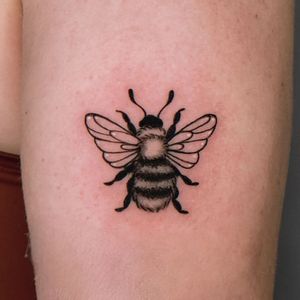 Stunning blackwork bee design on arm, expertly executed by the talented artist Erin. A unique and bold tattoo choice.