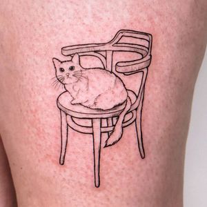 Unique blackwork tattoo on upper leg featuring cat and chair motif, by Erin.