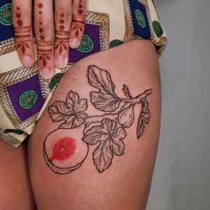 Illustrative upper leg tattoo featuring a stunning combination of flowers and fruits, expertly done by tattoo artist Erin.