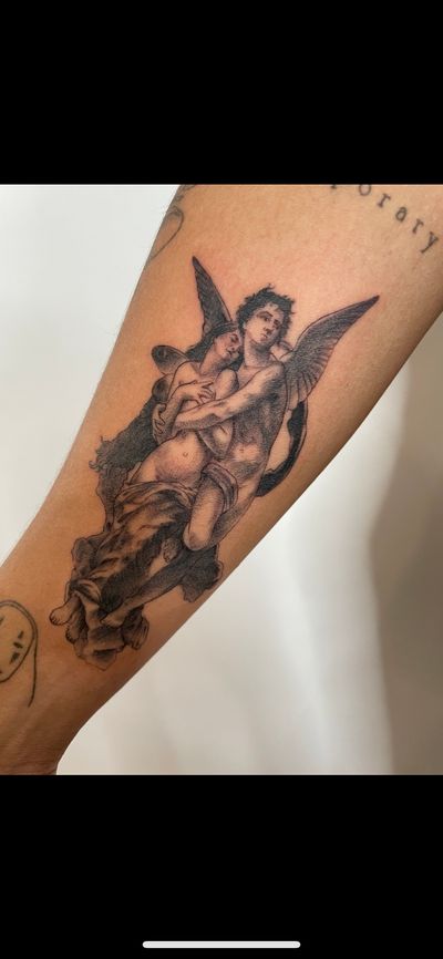 Capture the divine with a captivating black and gray angel tattoo by Ermis Atzemoglou. Elevate your arm with heavenly beauty.