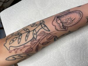 Elegant and delicate fine line tattoo featuring a leaf and vase motif, expertly done by Ermis Atzemoglou on the forearm.