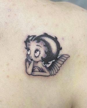 Beautiful black and gray Betty Boop tattoo by Sophie Rose Hunter, perfectly placed on the upper back.