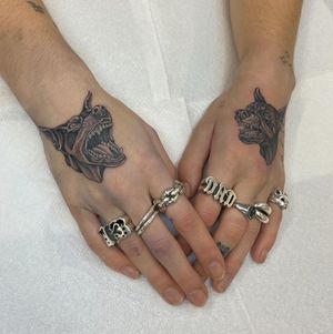 Artist Sophie Rose Hunter creates a stunning black and gray dog motif tattoo on hand. Perfect for pet lovers.