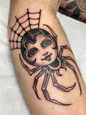 A stunning black & gray neo-traditional tattoo of a surreal spider woman, beautifully crafted by Sophie Rose Hunter on the arm.