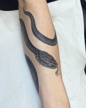 Sophie Rose Hunter's black and gray traditional snake tattoo on lower leg
