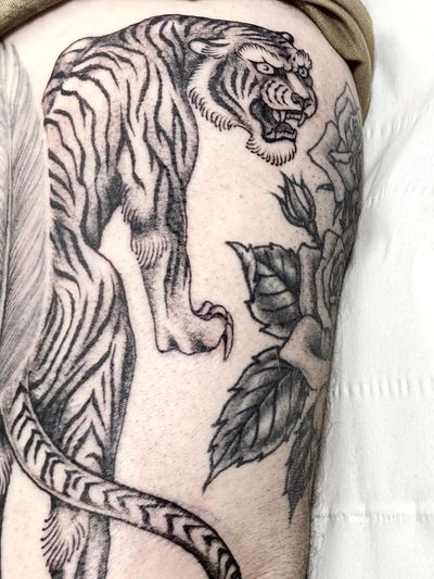Get a fierce and timeless Japanese tiger tattoo by Sophie Rose Hunter, perfect for your upper arm. Embrace the traditional style and make a bold statement.