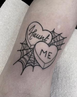 Small traditional lettering tattoo featuring a heart and spider web design by Federico Colantoni, perfect for lower leg placement.