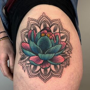 Beautiful floral design by Karen Buckley combining intricate dotwork with peony and mandala motifs on the upper leg.