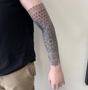 Adorn your arm with an intricate dotwork and geometric pattern design by the talented artist Karen Buckley.