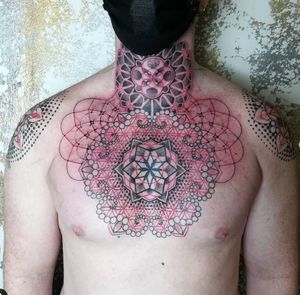 Get mesmerized by Karen Buckley's geometric pattern mandala tattoo, beautifully crafted in dotwork style on your chest.