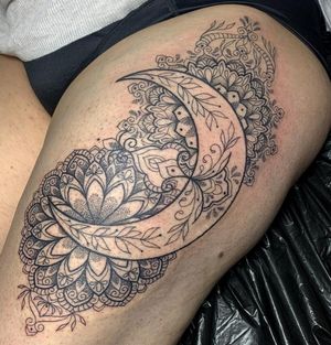 Embrace the beauty of the moon and intricate mandala design on your upper leg. By Karen Buckley.