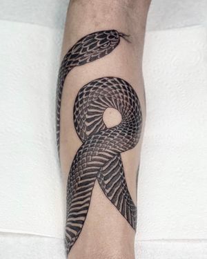 Get mesmerized by this stunning black and gray snake tattoo expertly crafted by the talented tattoo artist Sophie Rose Hunter.