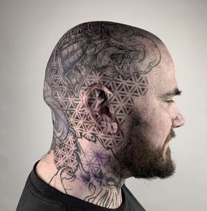 Discover the intricate patterns created by artist Karen Buckley with this unique dotwork design on the side of the face.