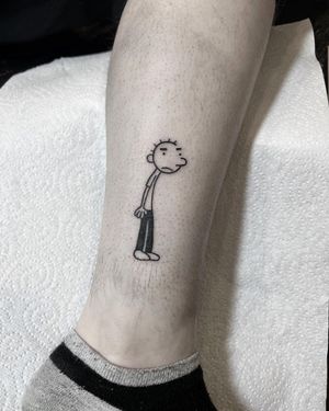 A beautifully detailed fine line tattoo of a kid on the lower leg, created by the talented artist Federico Colantoni.