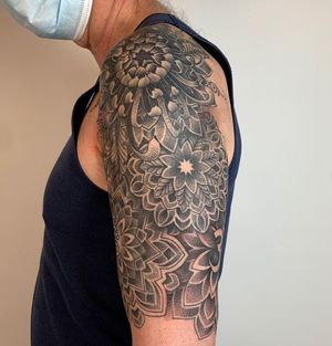Unique dotwork design by tattoo artist Karen Buckley, perfect for upper arm placement.