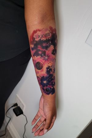Watercolor tattoo.  Galaxy space themed tattoo.  Small cover-up. Medium- dark skin tone.  Done at Art Collector Tattoo by Nik Lucas