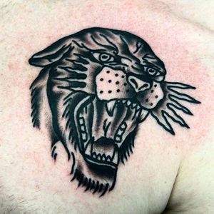 Experience the power and beauty of a traditional panther tattoo on your upper back by the talented artist Alessandro Lanzafame.