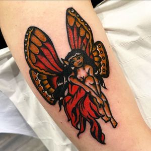 Capture the enchanting beauty of a fairy on your arm with this timeless traditional style tattoo by Alessandro Lanzafame.