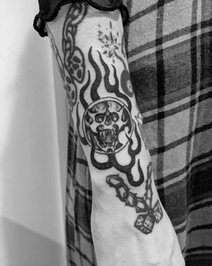 Bold blackwork skull and pattern tattoo on forearm by Shane, featuring intricate illustrative design