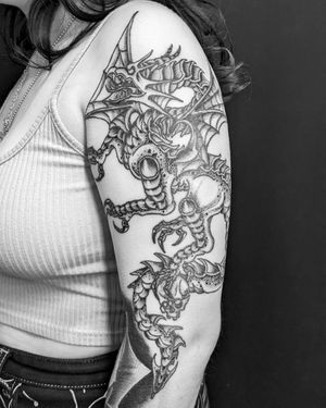 Embrace the power of an intricately designed dragon tattoo by Shane. A striking blackwork piece that will make you stand out.