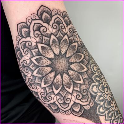 Intricate dotwork design with geometric patterns and mandala motif by tattoo artist Karen Buckley.