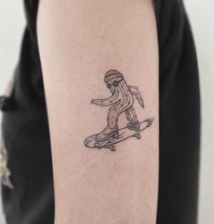 Unique blackwork cactus, glasses, and skateboard tattoo by Polina, perfect for the upper arm. Express your love for skating and the desert in style.