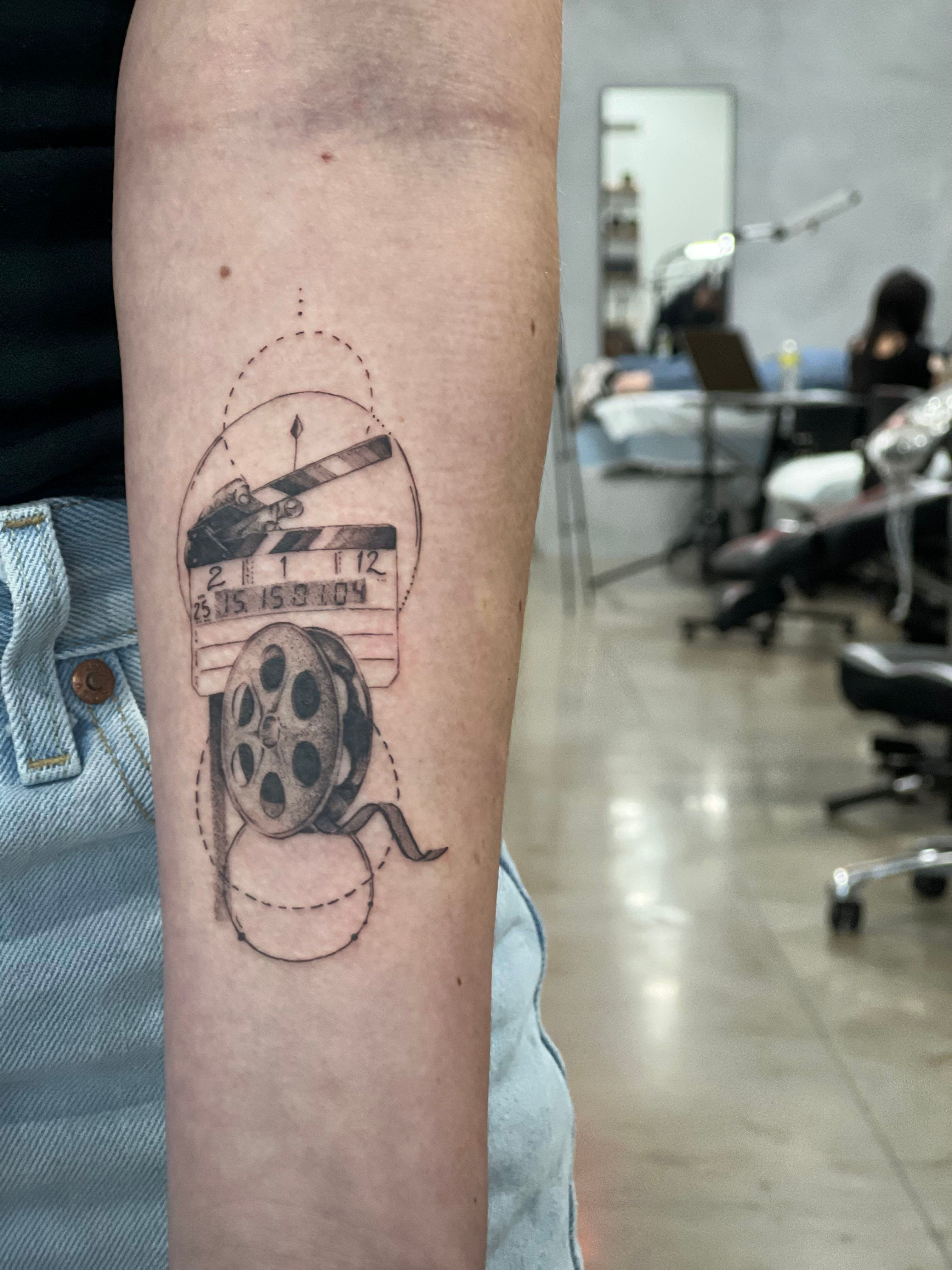 A cinema screen tattoo idea | TattoosAI