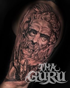 Get a striking black and gray illustrative design of a man statue on your upper arm, crafted by Corei.