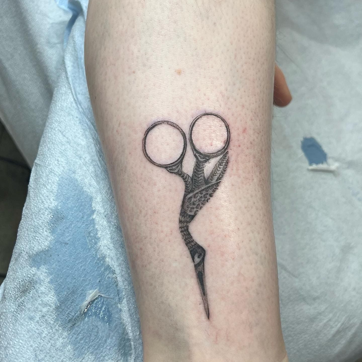 Comb and hairdressing scissors tattooed on the wrist.
