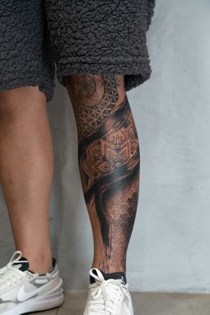 Experience the detailed artistry of Lawrence's blackwork and dotwork mandala design on your lower leg.