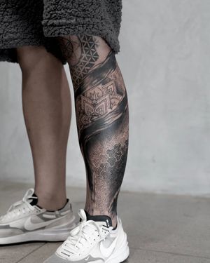 Unique blackwork and dotwork lower leg tattoo featuring a beautifully detailed mandala design by Lawrence