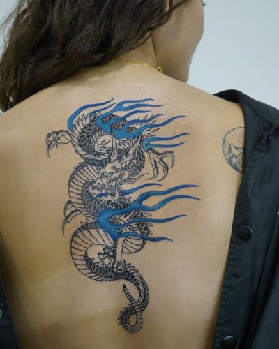 Immerse yourself in the power and beauty of a Japanese dragon with this stunning back tattoo by the talented artist Kotaro.