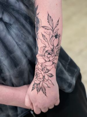 Express your style with this intricate blackwork flower design on your forearm. Handcrafted by the talented artist Lawrence.