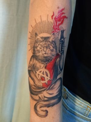 tattoo of a Saint Anarchy Cat, ready to burn the establishment to the ground (figuratively speaking) with a cocktail Molotov in hand. This piece is a reminder to always question authority and to never underestimate the power of a good drink.Viva La Resistance