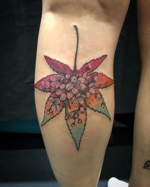 Stunning lower leg tattoo featuring delicate flower and leaf motifs, created by the talented artist Aygul.