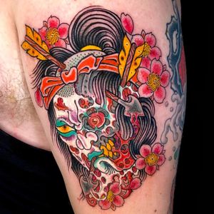 Experience the fusion of traditional Japanese style with a modern new school twist in this striking upper arm tattoo design featuring an arrow and namakubi motif, expertly executed by the talented artist Matthew Ono.
