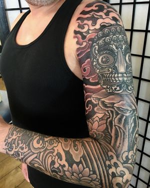Immerse yourself in a stunning blend of clouds, flowers, and skulls in this unique and intricate blackwork sleeve by the talented artist Kiko Lopes.