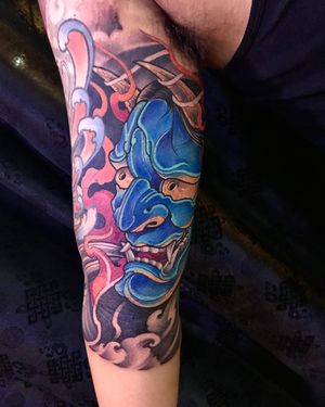 Elegant illustrative design of a hannya mask with intricate filigree details, beautifully done on the upper arm by Avi.