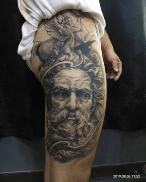 Avi's stunning black and gray tattoo combines a majestic horse with Poseidon, an angel, and a man in a realistic illustrative style on the upper leg.