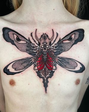 Unique black and gray dotwork design by Fernando Joergensen, combining a butterfly and skull motif on the chest.