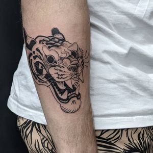 Bold and fierce tiger design by renowned artist Luca Salzano, perfect for your forearm. Embrace the strength and power of the tiger with this traditional Japanese style tattoo.