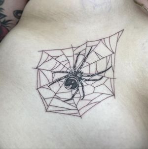 Explore the dark beauty of blackwork with this intricate spider design by Letitia Mortimer. Perfectly placed on the sternum.